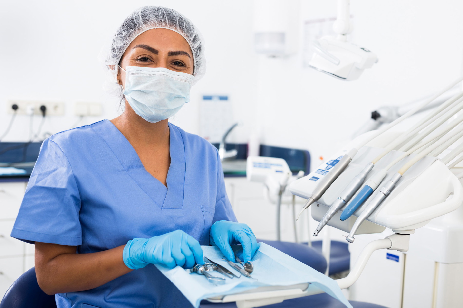 Woman dentist preparing medical tools in dental office