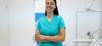 Confident patient care technician her medical office