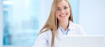 Healthcare management professional on a laptop.