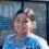Ingrid S., a Healthcare Career College graduate, wearing colorful scrubs and smiling outdoors