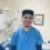 Alfonso Velazquez, an employed graduate of the Dental Assistant Program, smiling in a dental clinic with dental equipment in the background