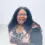 Portrait of Healthcare Career College student Cher wearing glasses and smiling
