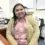 Daisy Andrade, an employed graduate of the Medical Biller and Coder program, smiling in an office setting